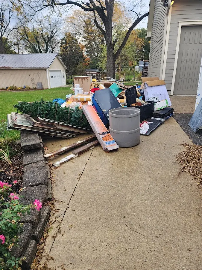 Dumpster being loaded with debris for Commercial Dumpster Rental in Shrewsbury